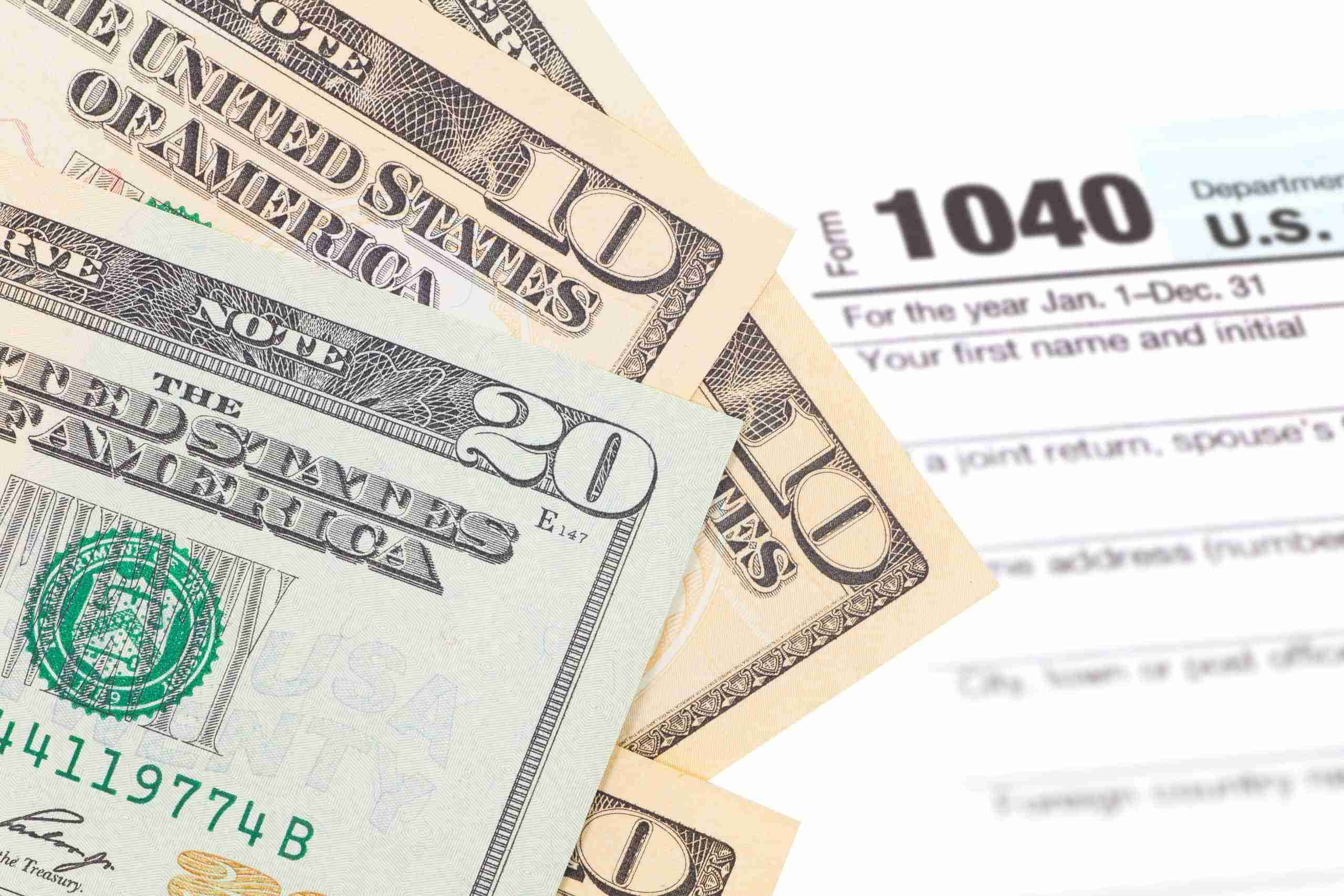 Money laid over the top of a tax refund form